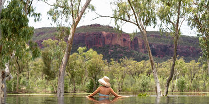 Lady enjoying pool views of Australian outback